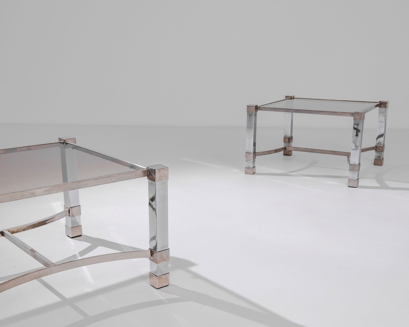 Pair Maison Charles Style Glass Top Tables: Mid century chrome and glass top side table pair. IMO Maison Charles. Dimensions: H 14.25" x W 23.25" x D 22" Origin: France, 1960** Please Note: All items are located in High Point, NC. Please read T