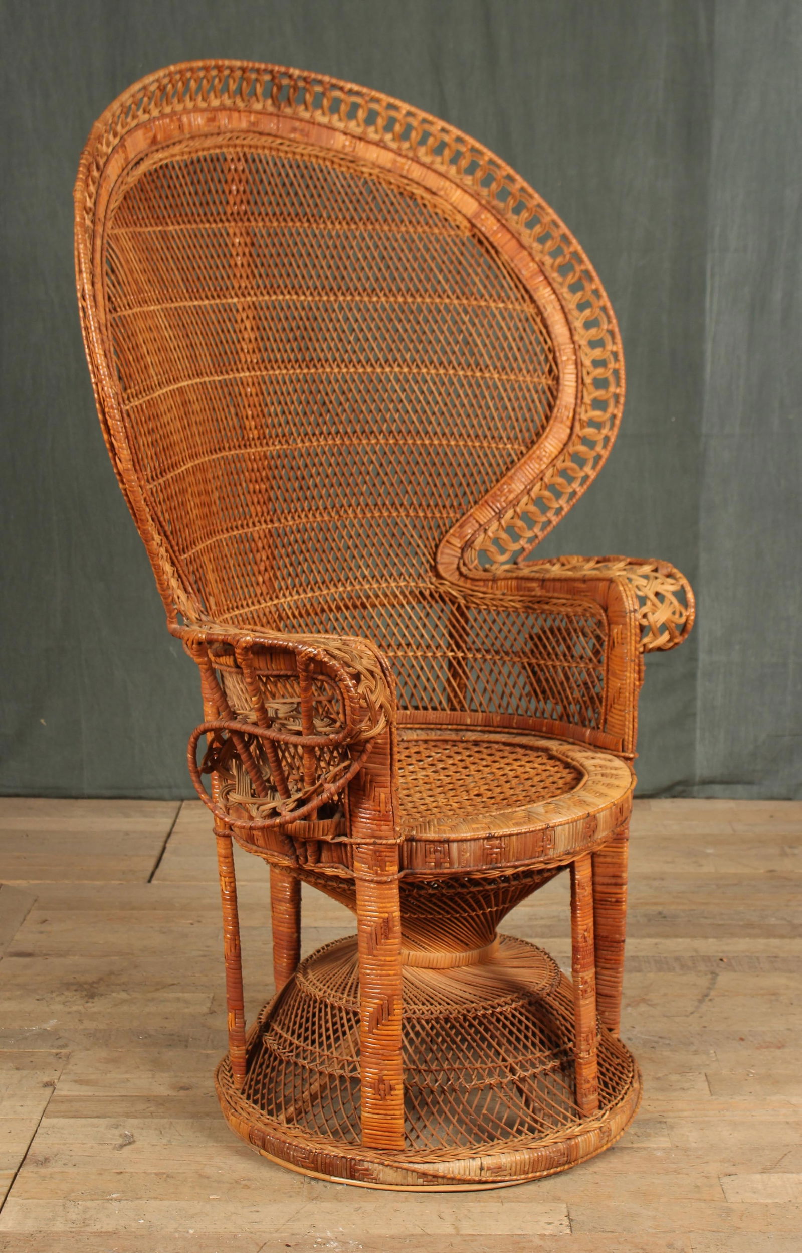 Wicker Fan Back Chair: A good antique vintage wicker fan back peacock chair with twisted scroll work arms and a caned seat on hour glass base. Size: 53"H x 38"W x 20"D