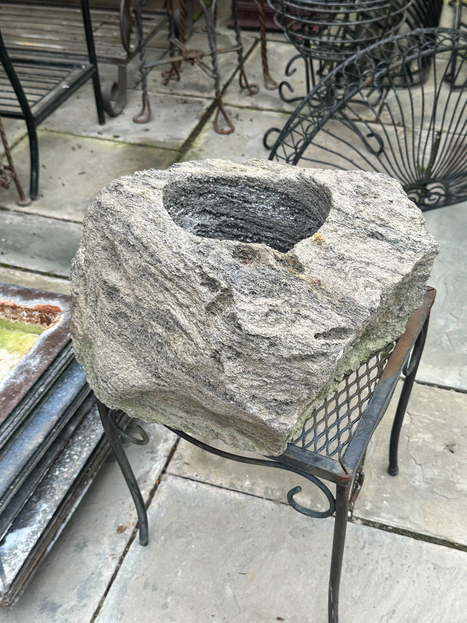 Carved Lava Rock Planter: Single piece of carved lava rock in the form of a planter. Lighter then you expect. Perhaps tuffo or pumice. Table not included. Size: 8.5"T x 11"L x 12"W irregular