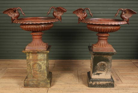 Pair Cast Iron Swan Handled Urns on Pedestals: Cast iron urns with swan details. Size: 27"H x 39"W across wings. Urn 20"H x 29"'Dia