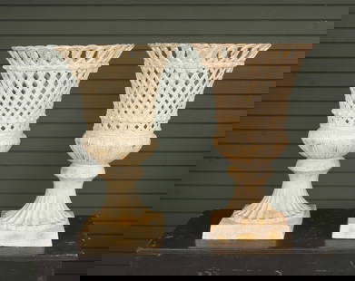 2 Pierced Basket Weave Urn Form Planters: Cast iron pair of urns with basket weave openwork design. Size: 27.5"H x 17"Dia. on a 11" sq base