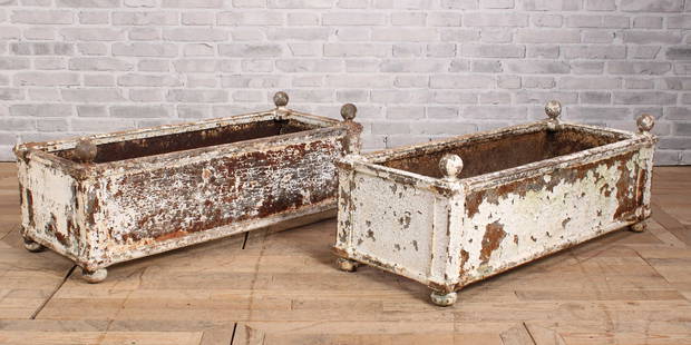 Antique Cast Iron Terrace and Garden Planters: A fine and rare pair of 19th Century cast iron Regency style terrace/garden planter having ball finials and paneled sides with column corners all raised on ball feet. Size: 17" x 49" x 18"