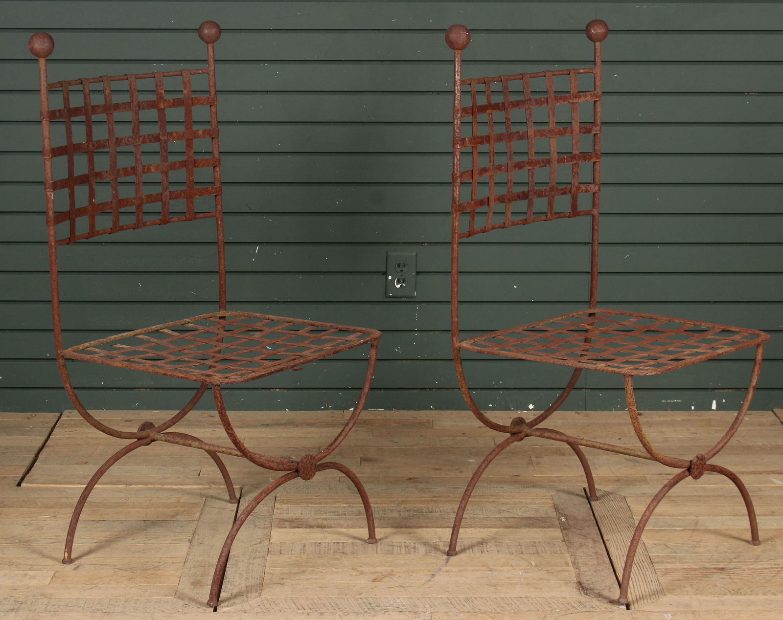 Pair French Taste Wrought Iron Chairs: A stylish pair of wrought iron garden chairs in the French taste having woven backs and seat all raised on curule base. Size: 41" H x 20" W x 19.5" D