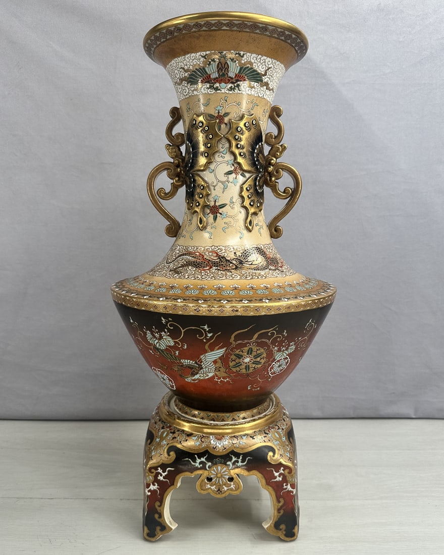 Satsuma Vase with Butterfly Handles on Stand: Wonderful scale on this Japanese Satsuma vase. Floral motifs with birds, dragons and butterfly handles. Gilding throughout. 2 pieces, vase and base. Size: 24"T x 10" diameter at widest
