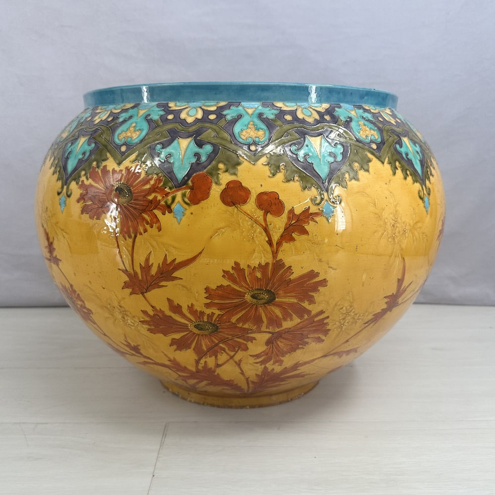 IMO Theodore Deck, Majolica Floral Jardiniere: Great scale on this vividly colored urn. Floral motif with Moroccan inspired border. Small chips to base and paint touch up as shown in photos. Size: 14"T x 14.5" diameter opening at top