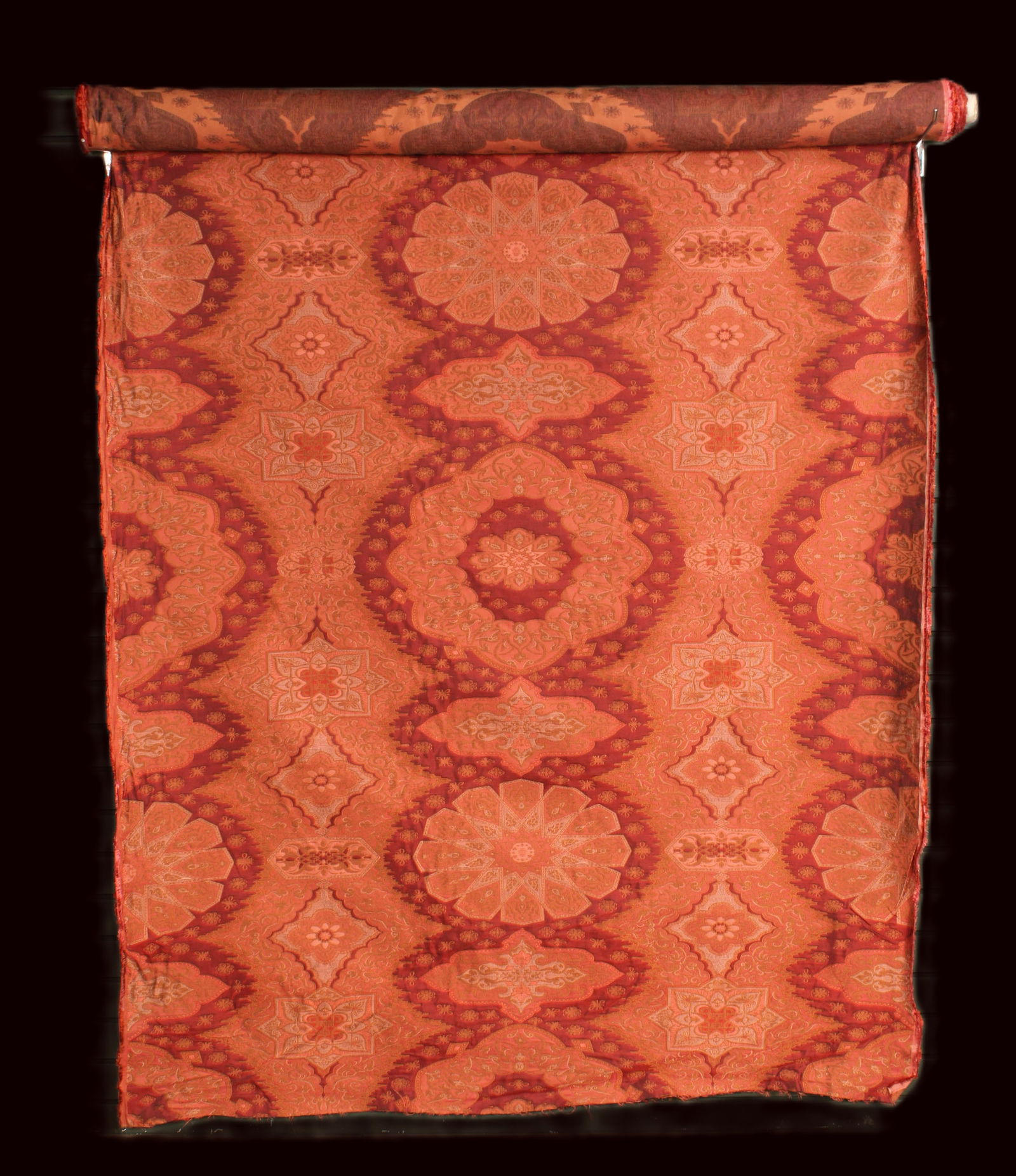 Bolt Brocade Damask Fabric: Bolt of brocade damask fabric in deep reds. Length unknown. Size: 55"W