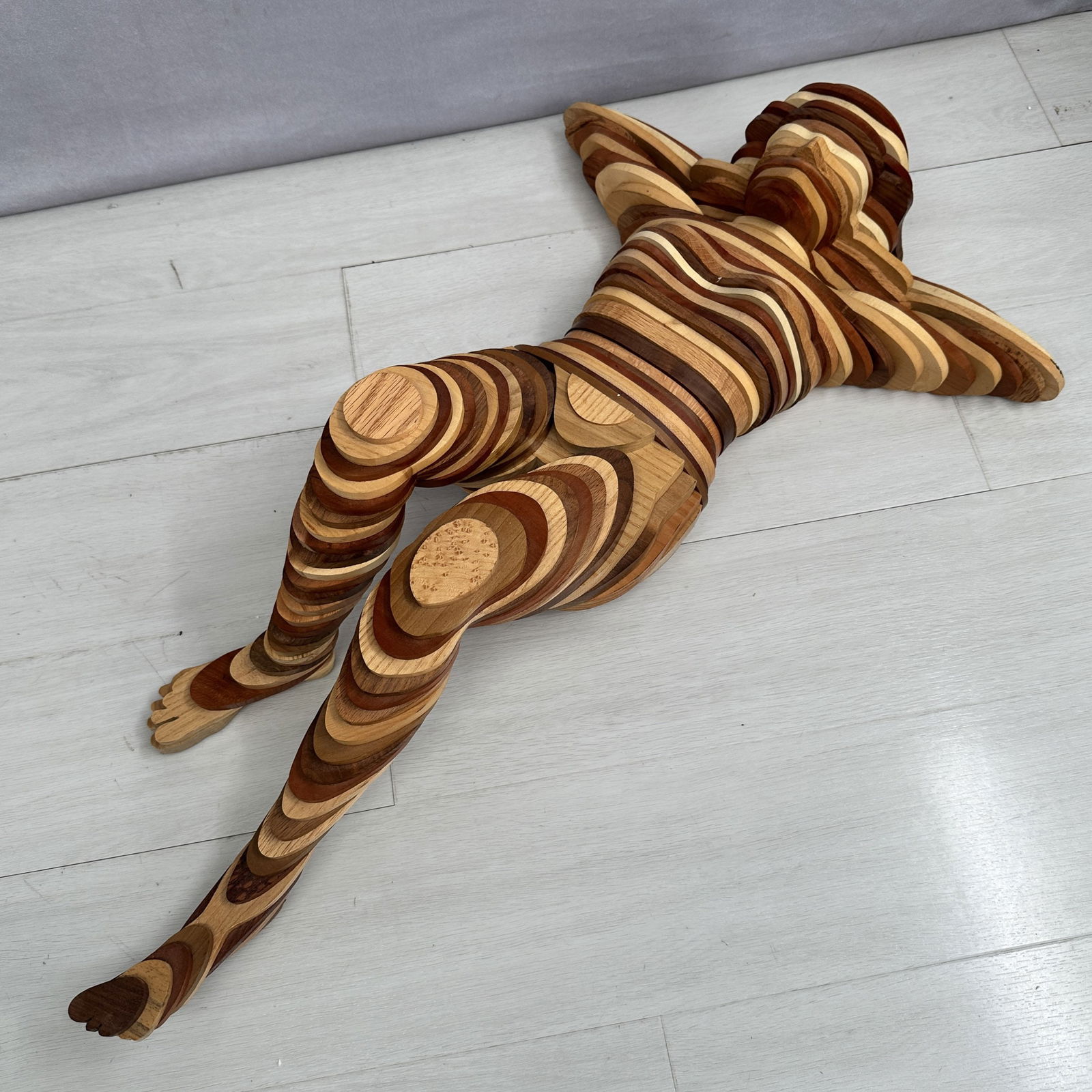 Wood Contour Sculpture, Reuben Karol: Interesting modernist sculpture of the female form made from various wood tiles that are glued and pressed together. Signed on bottom R.K., Reuben Karol. Size: 8"T x 31"L x 17.5"D