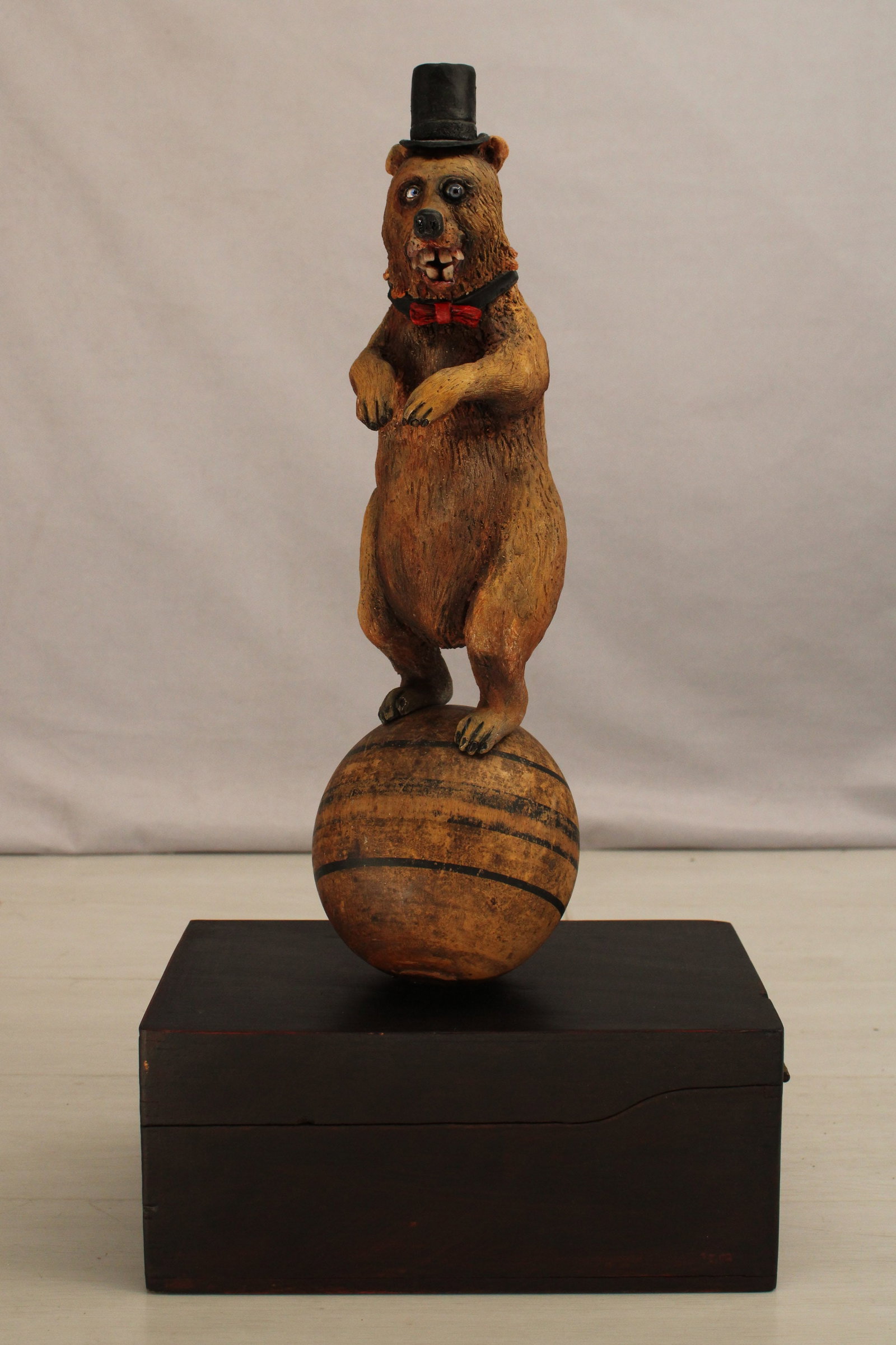 Bear On Ball Storage Box, Signed: Folk art circus bear balancing on a ball, on top of a small card catalog, trinket box. The bear is obviously the star of the show, the top hat, bow tie, glass eyes, and teeth that look far to human. S