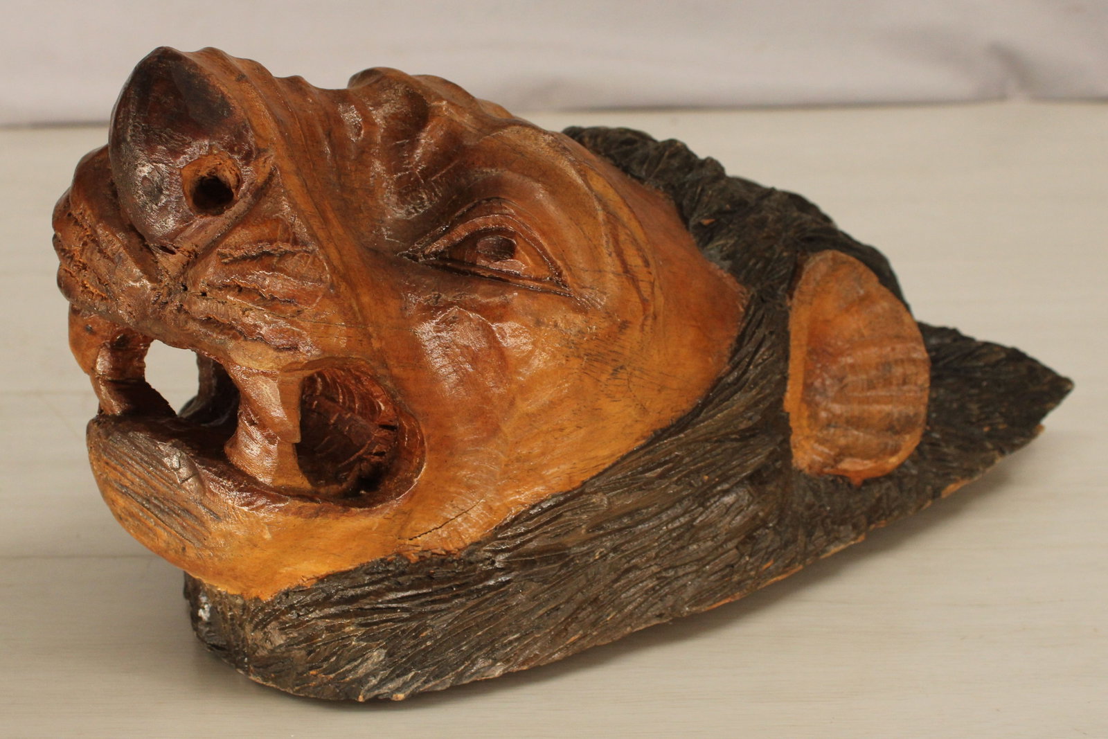 Carved Wood Lion Head: Folk art carved lion head, single piece of wood with two toned stain. Size: 13"T x 10"W x 7.25"D