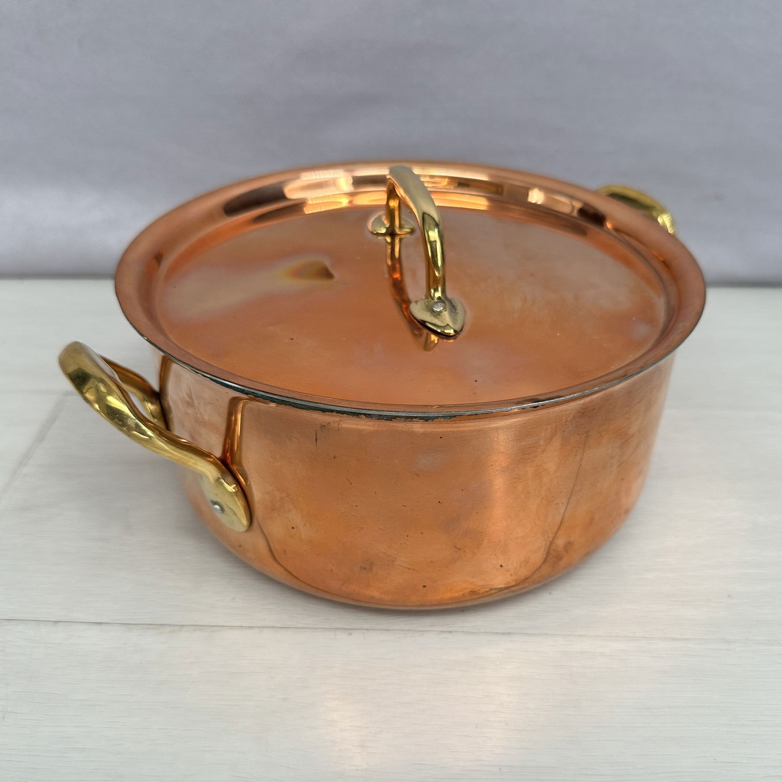 Copper pot with fitted lid and brass handles, no  marks, patina around top rim of one side. Size: (1 of 8)