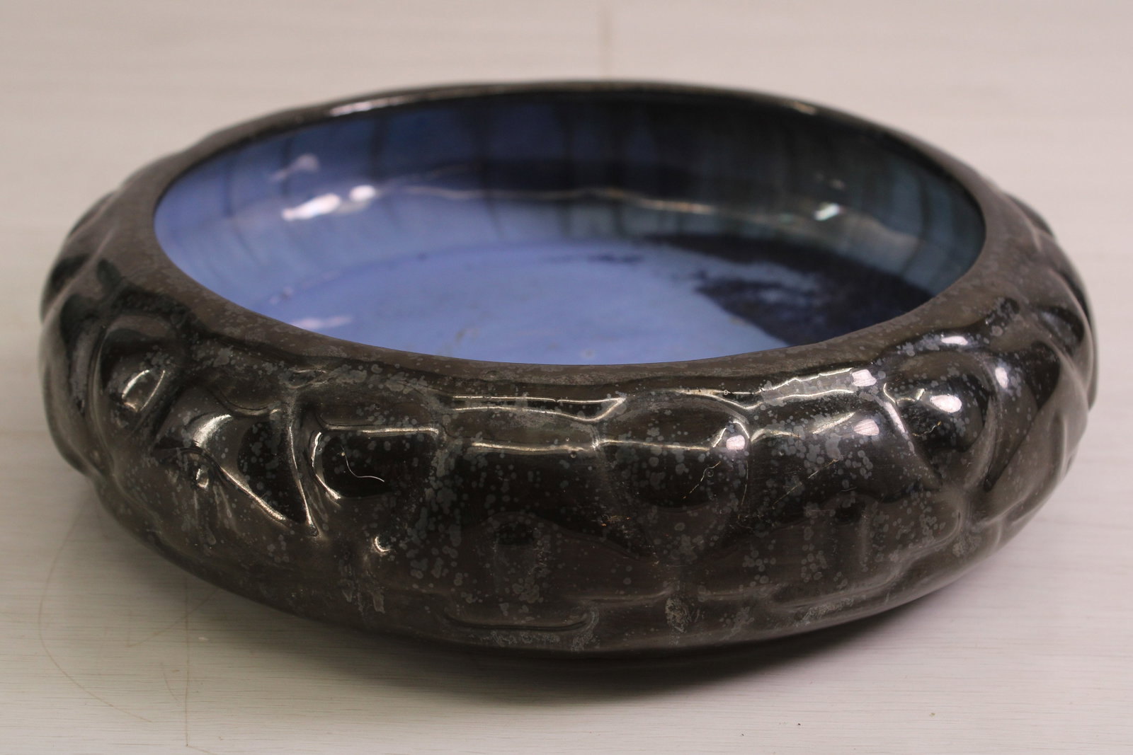 Fulper Pottery Bowl: Fulper Pottery bowl, black on speckled blue contrasting glaze, repeating raised pattern, stamped on bottom. 1917-1934 Size: 3"T x 10.5" diameter