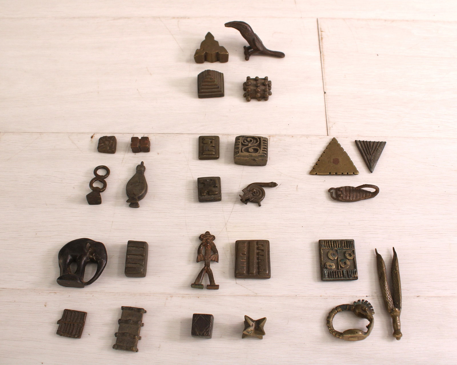 Ashanti Gold Dust Weights, Group of 26: Group of 26 assorted Ashanti Gold dust weights, figural, zoomorphic, and geometric shapes. Size: various, approximately 1-2.5"T