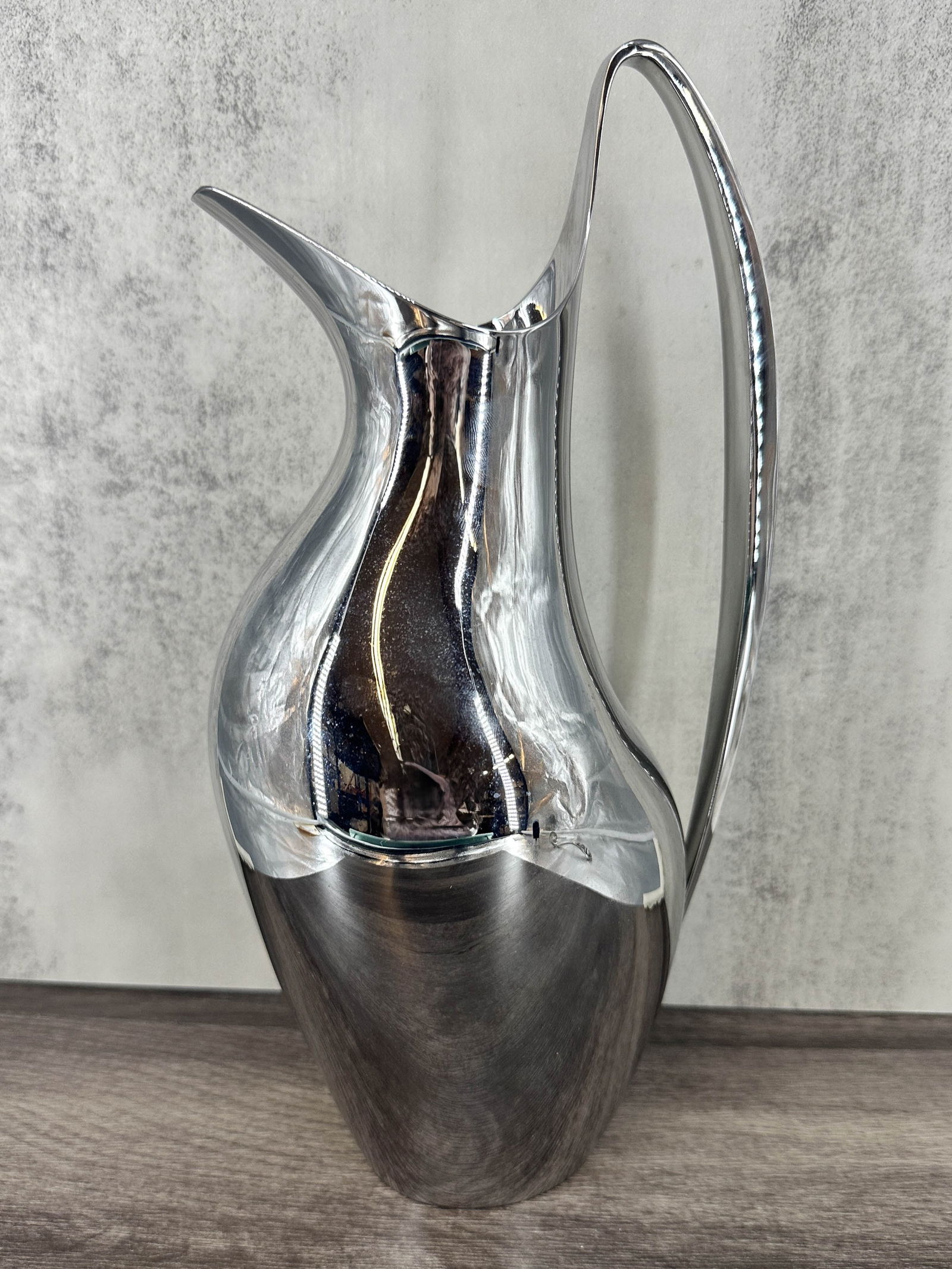 Georg Jensen Henning Koppel Pitcher, 1.2L: Henning Koppel for Georg Jensen mirrored stainless steel, pitcher, carafe. Marked on bottom, comes with original box. Size: 11"T x 5"L x 4"W; 1.2L volume