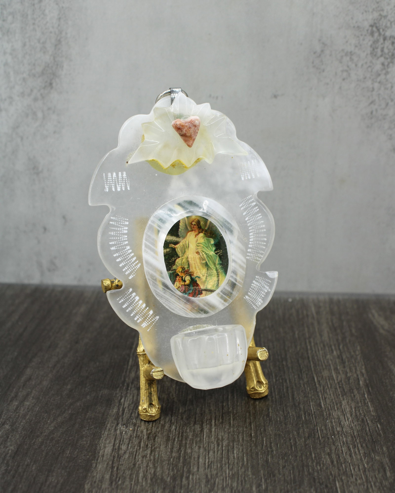 Carved Quartz Holy Water Font: Late 20th century carved quartz holy water fountain. Some yellowing to the glue. Photo is glued in, ready to hang. Comes in velvet pouch. Size: 4.5"T x 3"W x 1"D Stand or box not included.