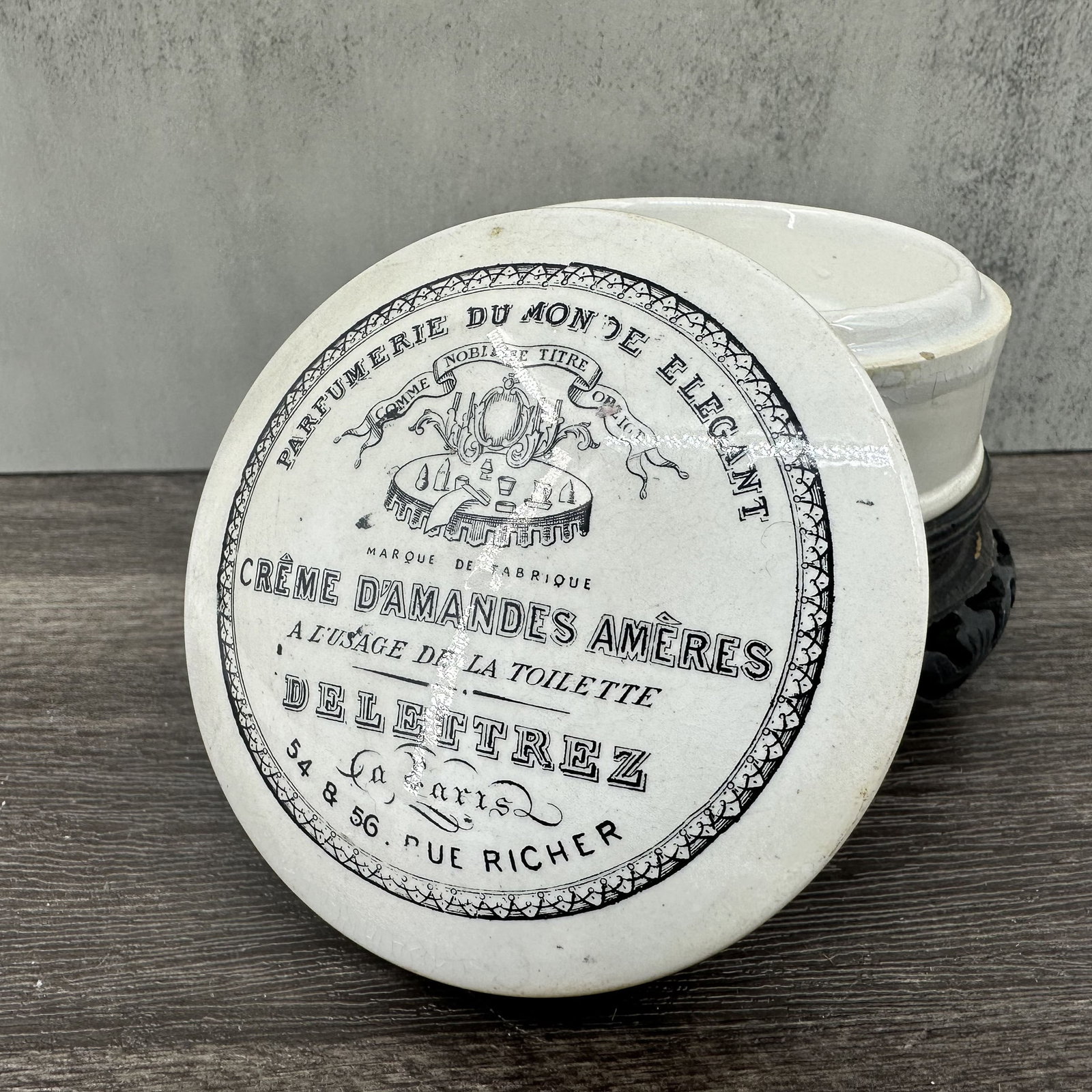 Antique French Apothecary Porcelain Pot: Antique French apothecary, beauty product in porcelain pot. Delettrez Creme D'Amandes Ameres or Creme de Almonds, made in Paris. Porcelain is starting to craze in spots and has tape remnants around th