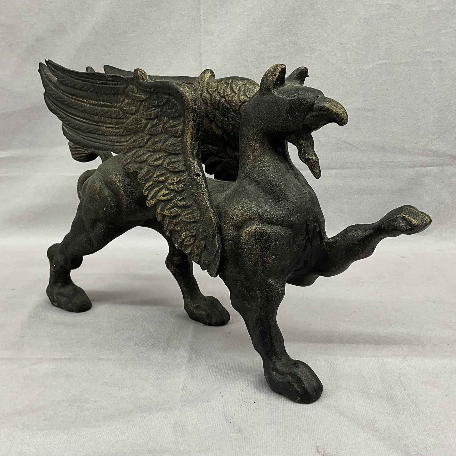 Cast Iron Griffin, Door Stop, Garden: Replica of a Victorian griffin door stop, this would look great as a garden decoration as well. very heavy, cast in 4 parts and welded together. Size: 8.5"T x 12.5"L x 3.25"W