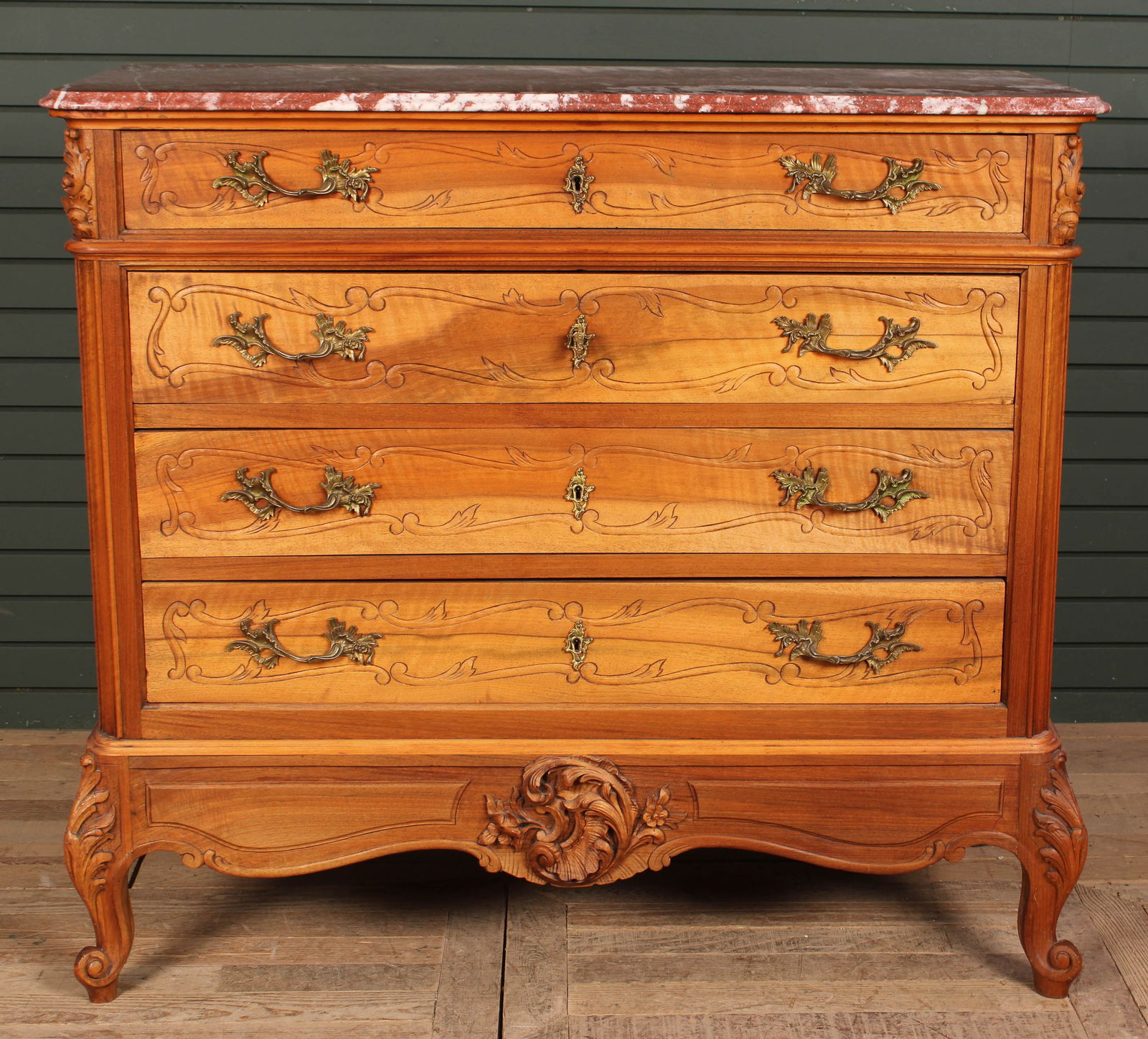French Marble Top Dresser, Carved Details: A French Turn of the Century commode having elegant marble top over four carved front drawers all raised on shaped feet. Size: 42"H x 45"W x 20"D
