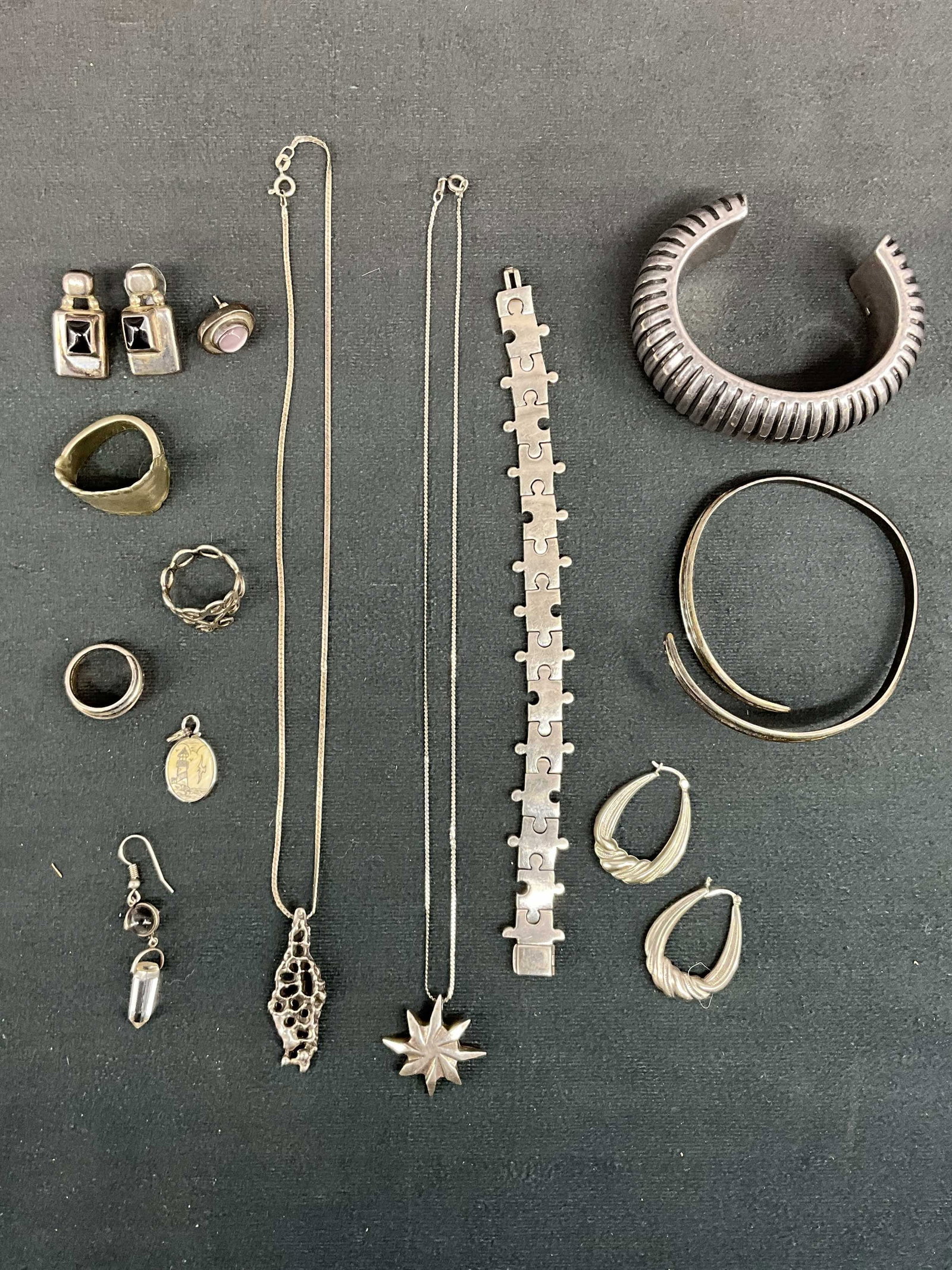 Sterling & Fine Silver Jewelry Lot: 2 necklaces, 3 bracelets, 3 rings, various earrings and charms. Stamps as seen in photos, some sterling silver. Cuff is Simon Sebang. Scrimshaw pendant with light house. Size: various, chains 18"L, ri