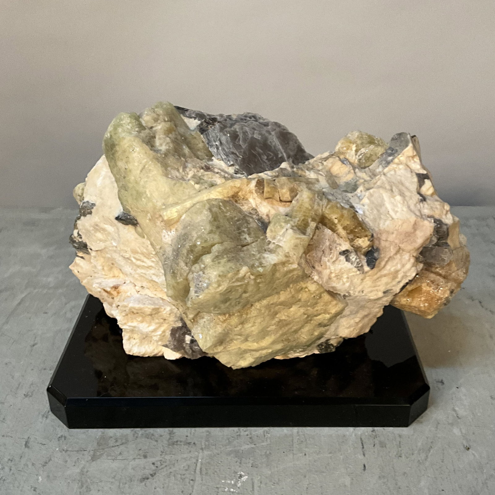 Green Beryl With Mica In Matrix: Sizeable chunks of green beryl in matrix with mica, black acrylic stand. Size: 6.5"T x 9"L x 6"D on stand Provenance: From the lifetime collection of an Orland, Pennsylvania private estate.