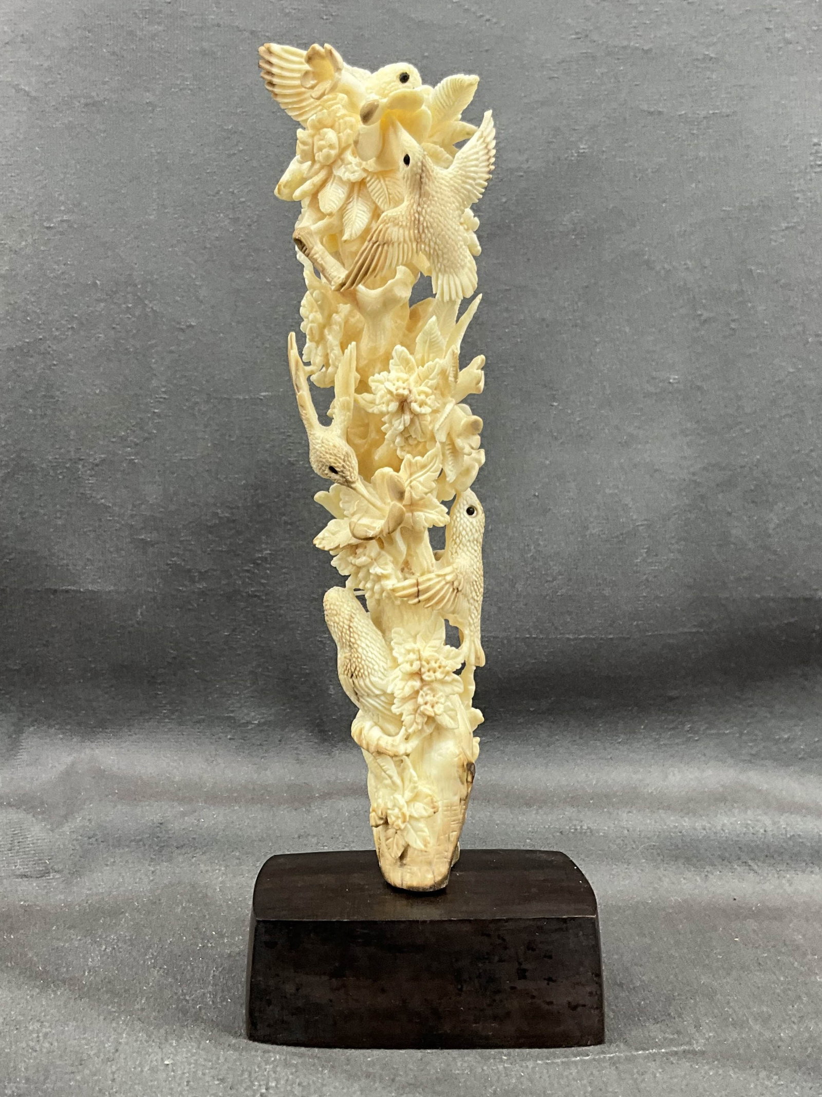 Carved Walrus Tusk Birds, Alaska: Intricately carved walrus tusk, birds and flowers on custom wood base. See photos for condition, crack at base. Origin Alaska. Size: 8"T x 3"W x 2"D Provenance: From the lifetime collection of an Orla
