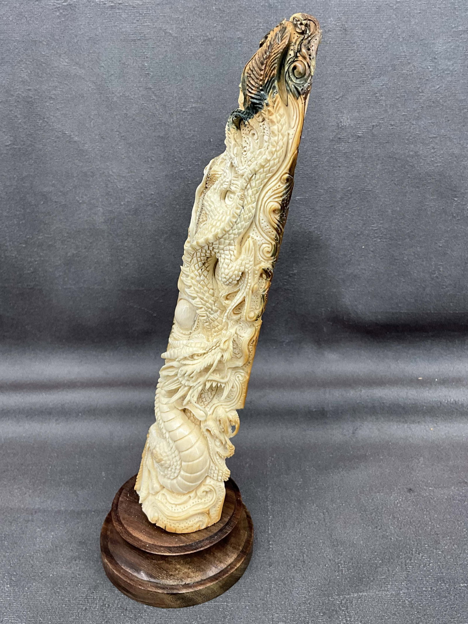 Mammoth Tusk Dragon Carving: Mammoth tusk from Siberia, carved on one side depicting a dragon. Custom wood base. Size: 9"T x 2.75" diameter Provenance: From the lifetime collection of an Orland, Pennsylvania private estate.