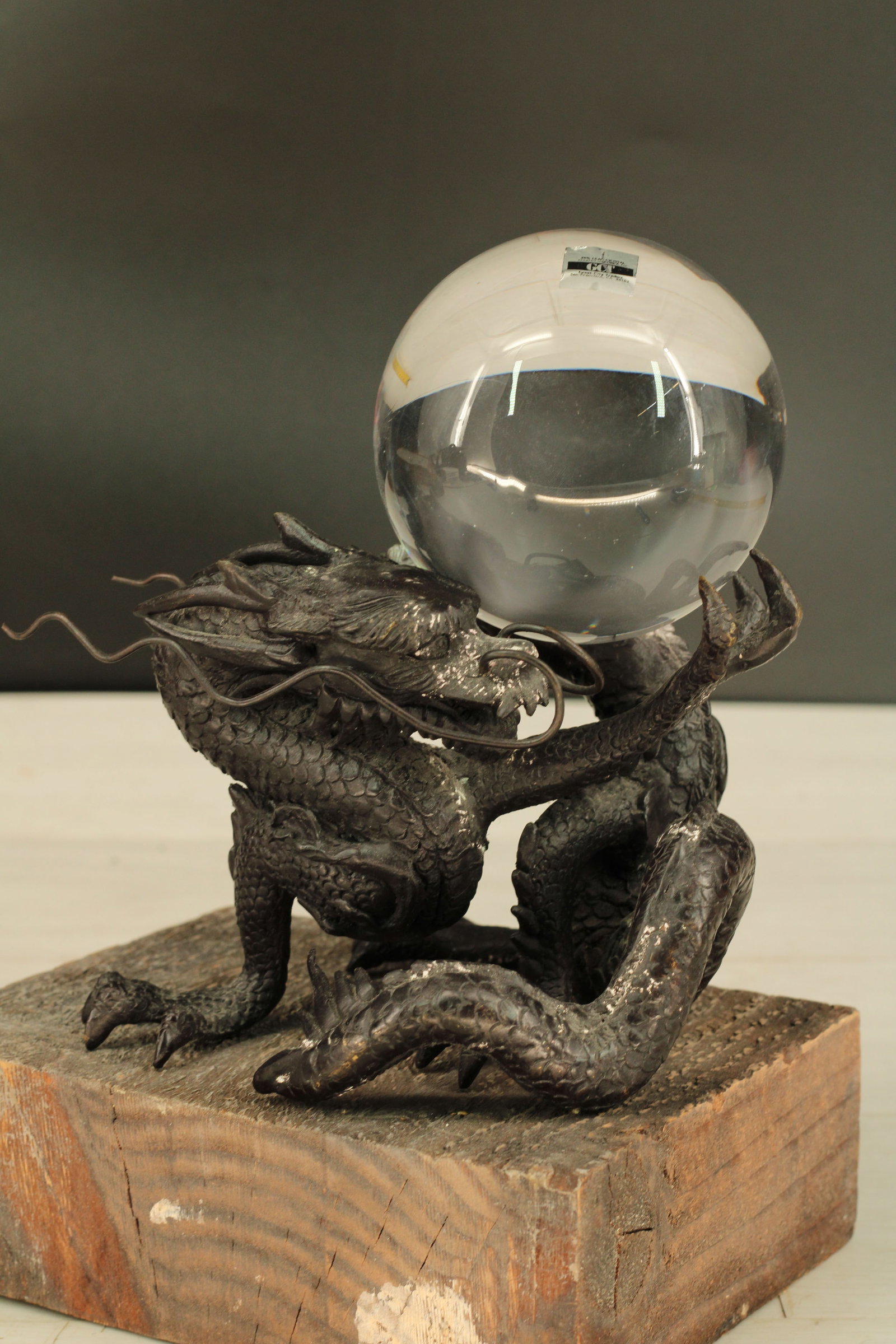 Crystal Ball on Figural Bronze Dragon Stand: Bronze dragon holding a crystal ball. Great City Traders Size: 8"H x 7"W x 6"D