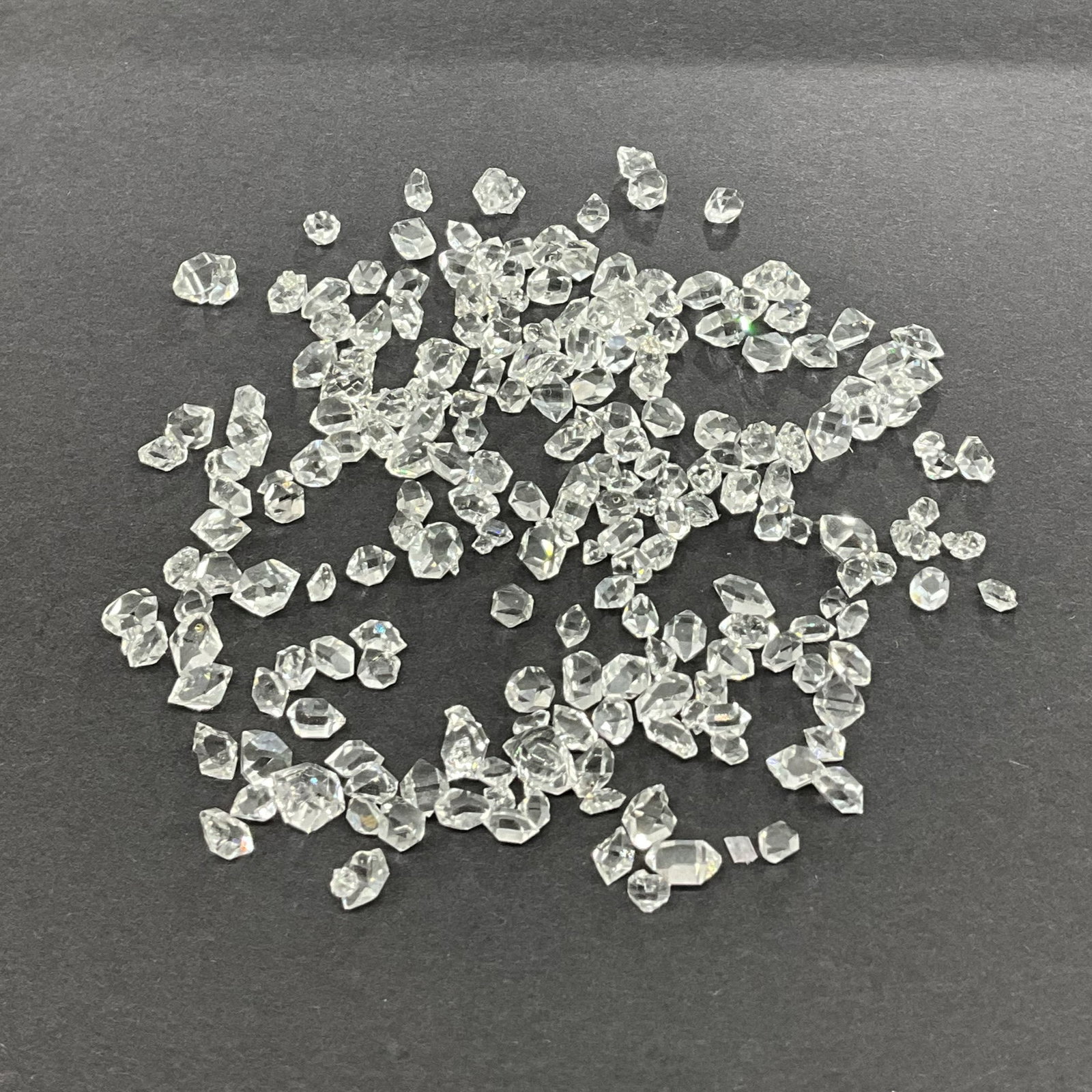 Diamond Chips, Loose: Diamond chips, tested positive on a diamond tester, various sizes and shapes. Great clarity and sparkle. Size: various, total weight 11g, 55 carats Provenance: From the lifetime collection of an Orela