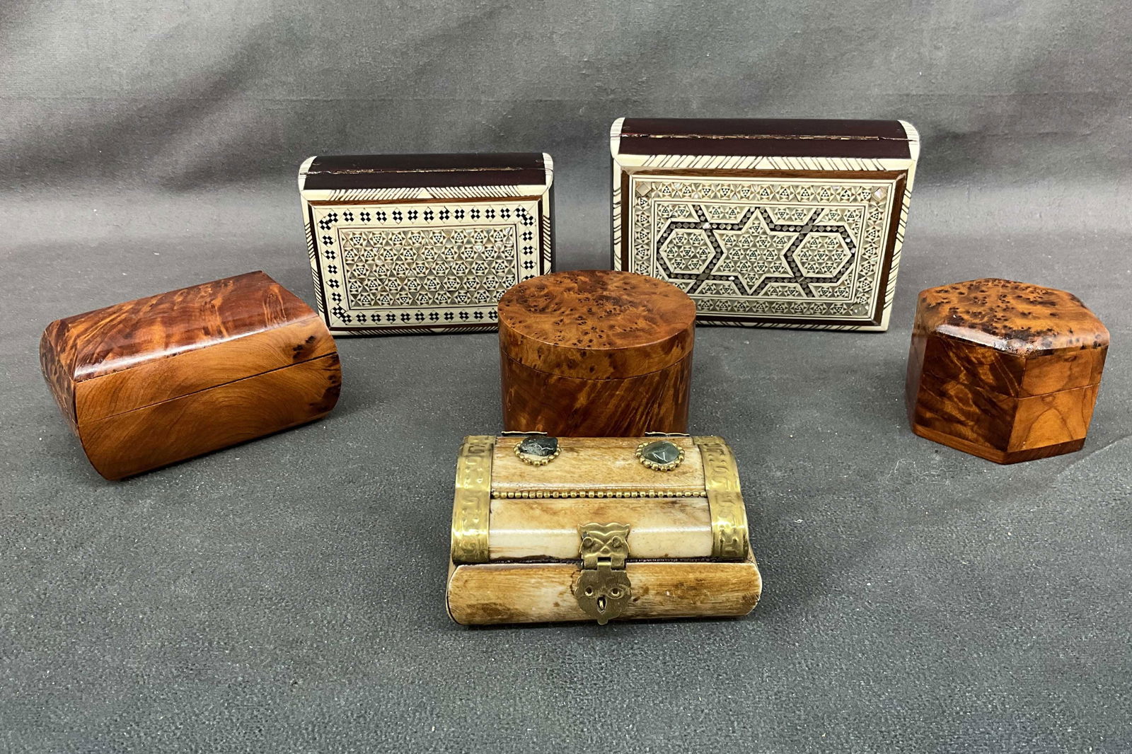 Selection of Wood Gift Boxes: Selection of wood boxes, 2 with bone & mother of pearl inlay, 1 carved bone, and 3 burl wood. Size: largest 2.5"T x 5.5"L x 4"D Provenance: From the lifetime collection of an Oreland, Pennsylvania pri