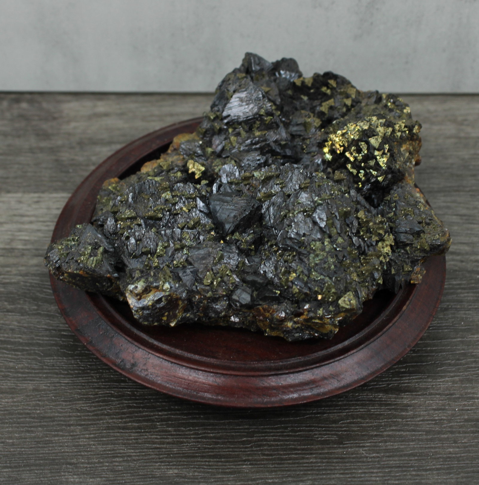 Tourmaline in Matrix on Stand: Black tourmaline crystals in matrix. Possibly corundum on the under side. Previously part of a larger collection hence the painted number on the bottom. Stand included. Size: 4" x 3.5" x 1" without st