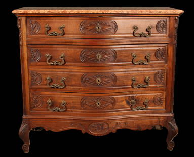 French Marble Top Dresser, Fossil Inclusion: A French late 19th to turn of the century marble top walnut serpentine front commode having four drawers with carved decoration and shaped feet. Bonus- beautiful ammonite fossil in the marble top. Siz