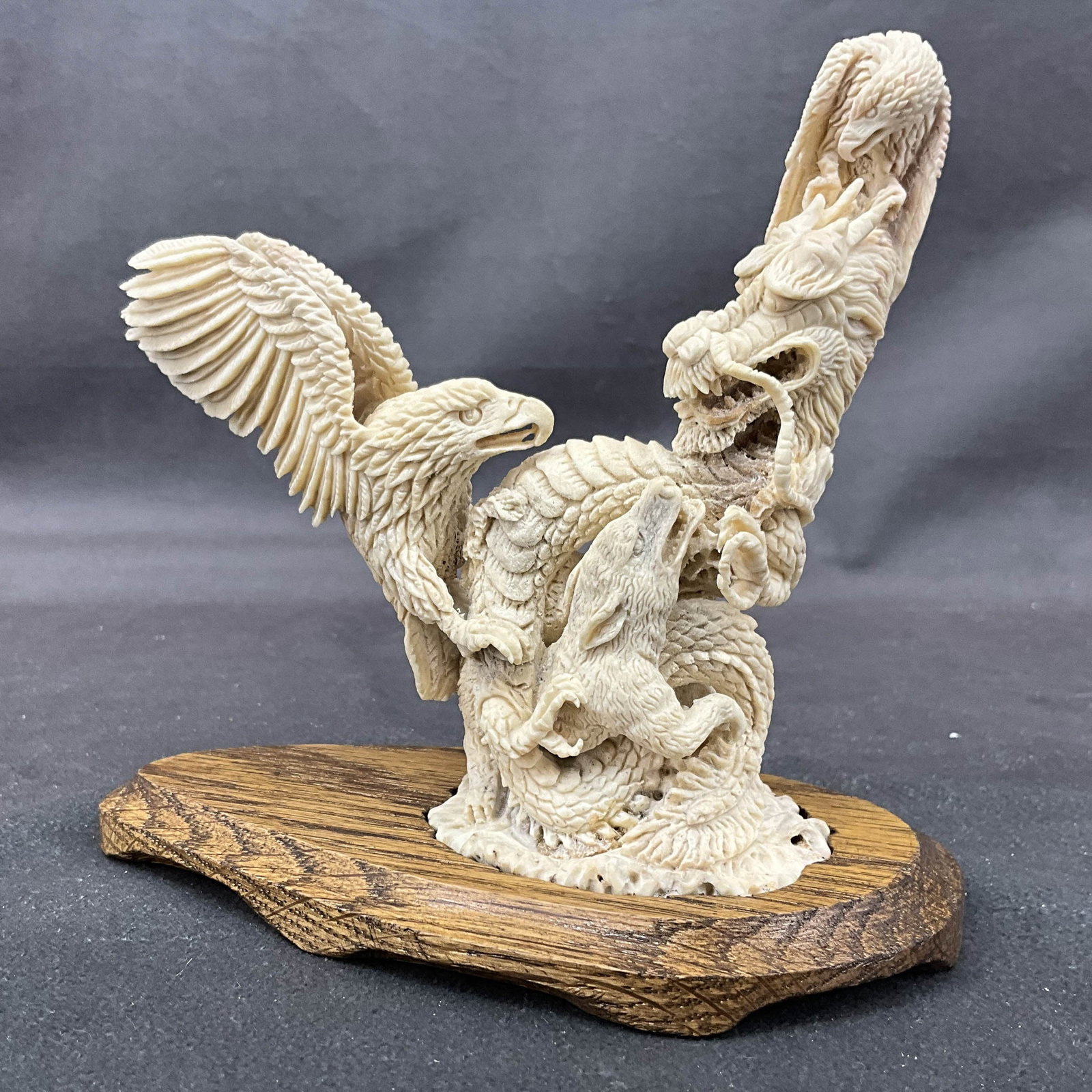 Dragon, Eagle, & Fox Group, Antler Carving: Carved antler with a dragon, eagles & foxes on custom wood base. Size: 5.25"T x 6"L x 3.25"D Provenance: From the lifetime collection of an Oreland, Pennsylvania private estate.