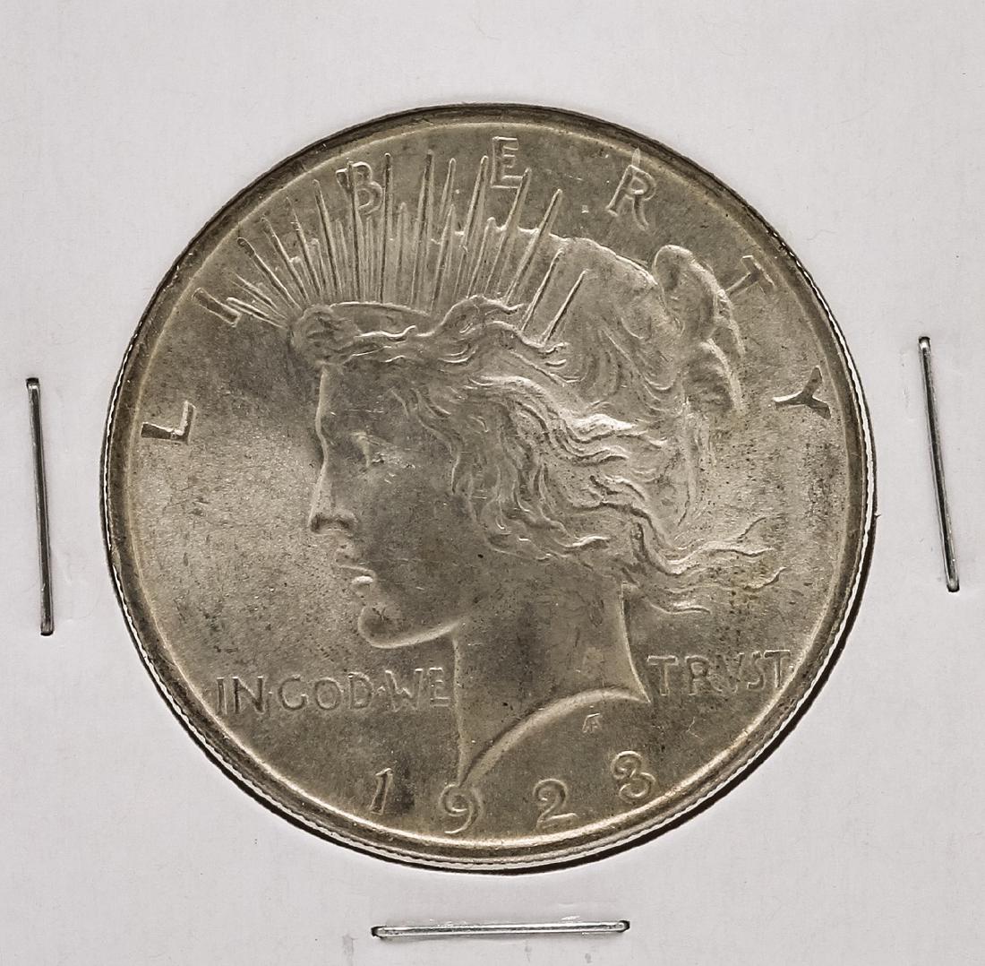 1923 $1 Peace Silver Dollar Coin: One 1923 $1 Peace Silver Dollar Coin.