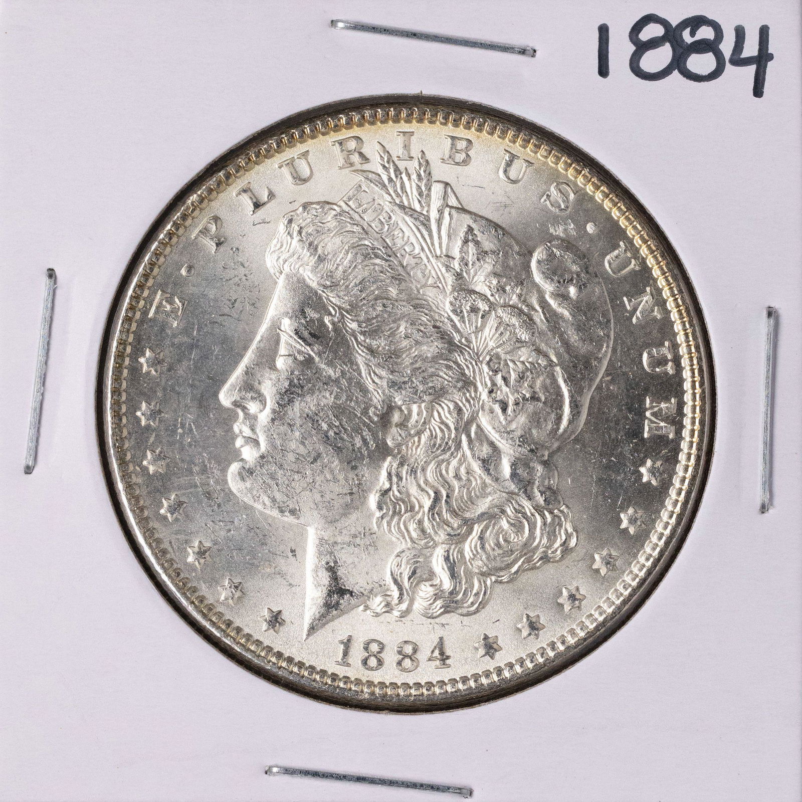 1884 $1 Morgan Silver Dollar Coin: One 1884 $1 Morgan Silver Dollar Coin.