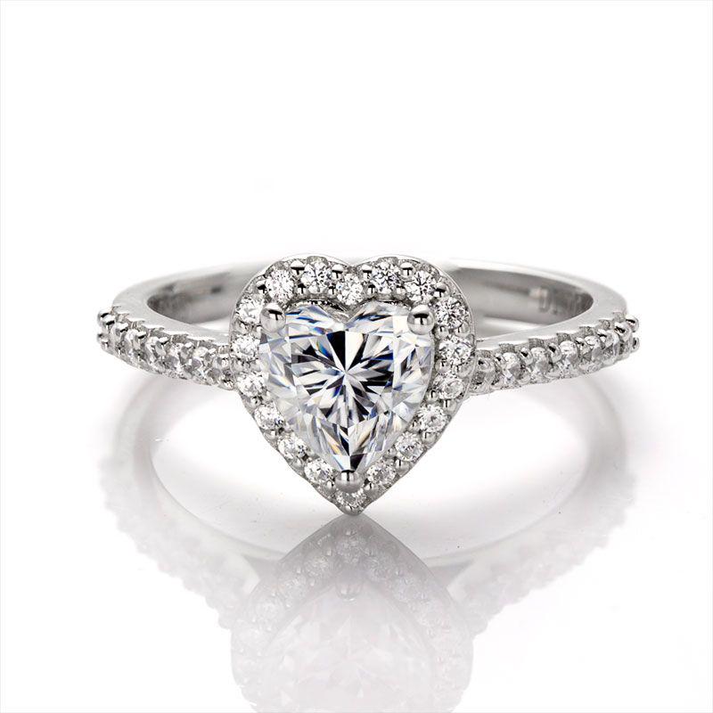 Sparkling 1 Ct VVS1 White F-G Fire Moissanite Ring: This Lovely 1 CT Heart Cut Moissanite Centerstone is a VVS1 Brilliant 6.5 mm. The Color is White G-H. It is near flawless and bursting out with a full spectrum of colors. This Moissanite Ring is compl