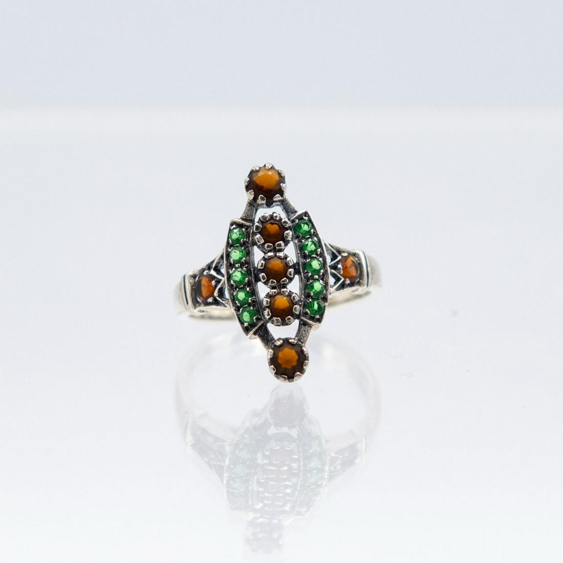 Gorgeous Natural Tsavorite Garnet Ring: Beautiful Natural Tsavorite Garnet and Rhodolite red Garnet Ring . Mounted in elaborately designed solid stamped .925 Sterling Silver Size 6. Total Gram wt 2.6 Grams Very Pretty Ring with Brilliant Cl