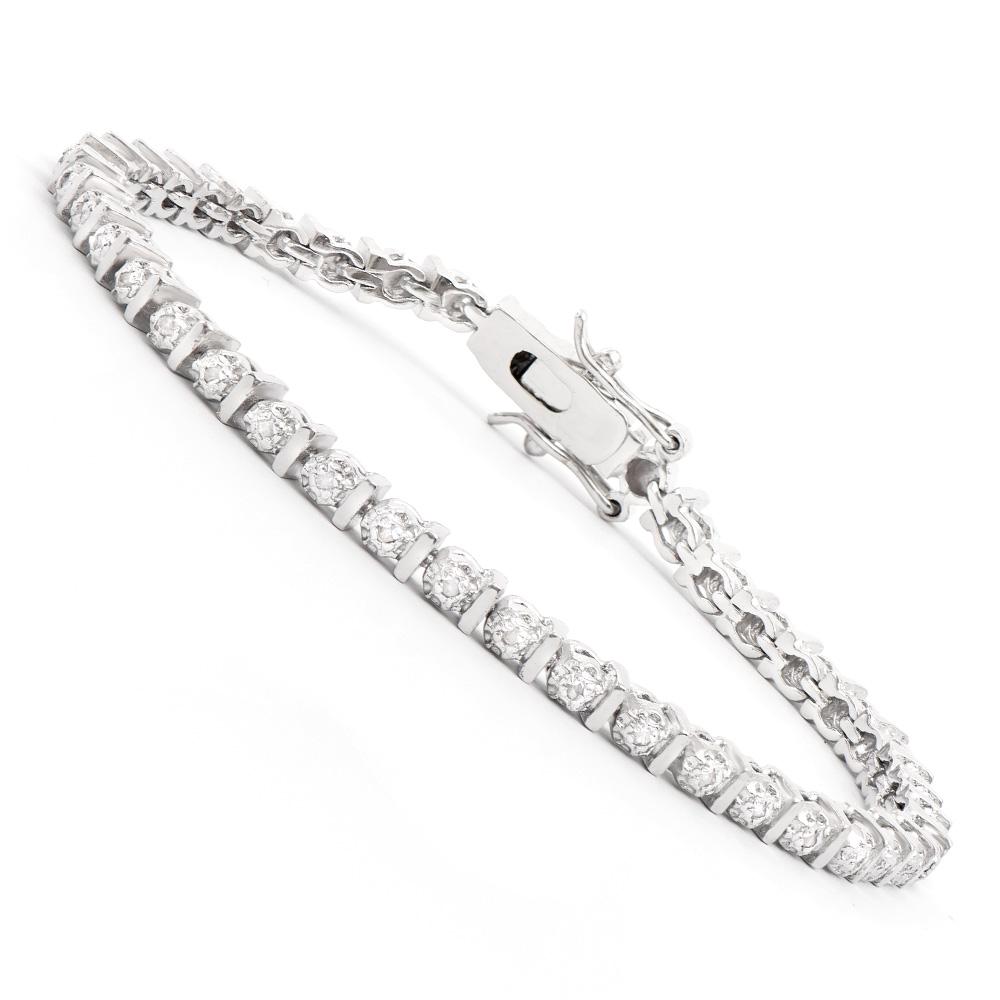 Plated Rhodium Diamond Bracelet: One Plated Rhodium Diamond Bracelet. Diamonds with a total weight of 0.15cts with a color of I-J and clarity of I-3. Total weight of this bracelet is 9.05 grams. The length of this bracelet is 7 1/2 i
