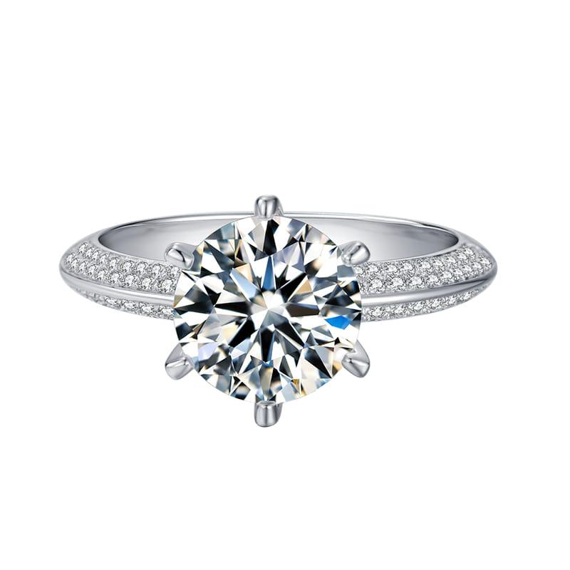 Sparkling 3Ct White Fire Moissanite Solitaire Ring: This Large 3 Ct Moissanite Centerstone is a VVS1 Brilliant 9 Cut. The Color is White G-H. It is near flawless and bursting out with a full spectrum of colors. This Moissanite Ring is complimented with