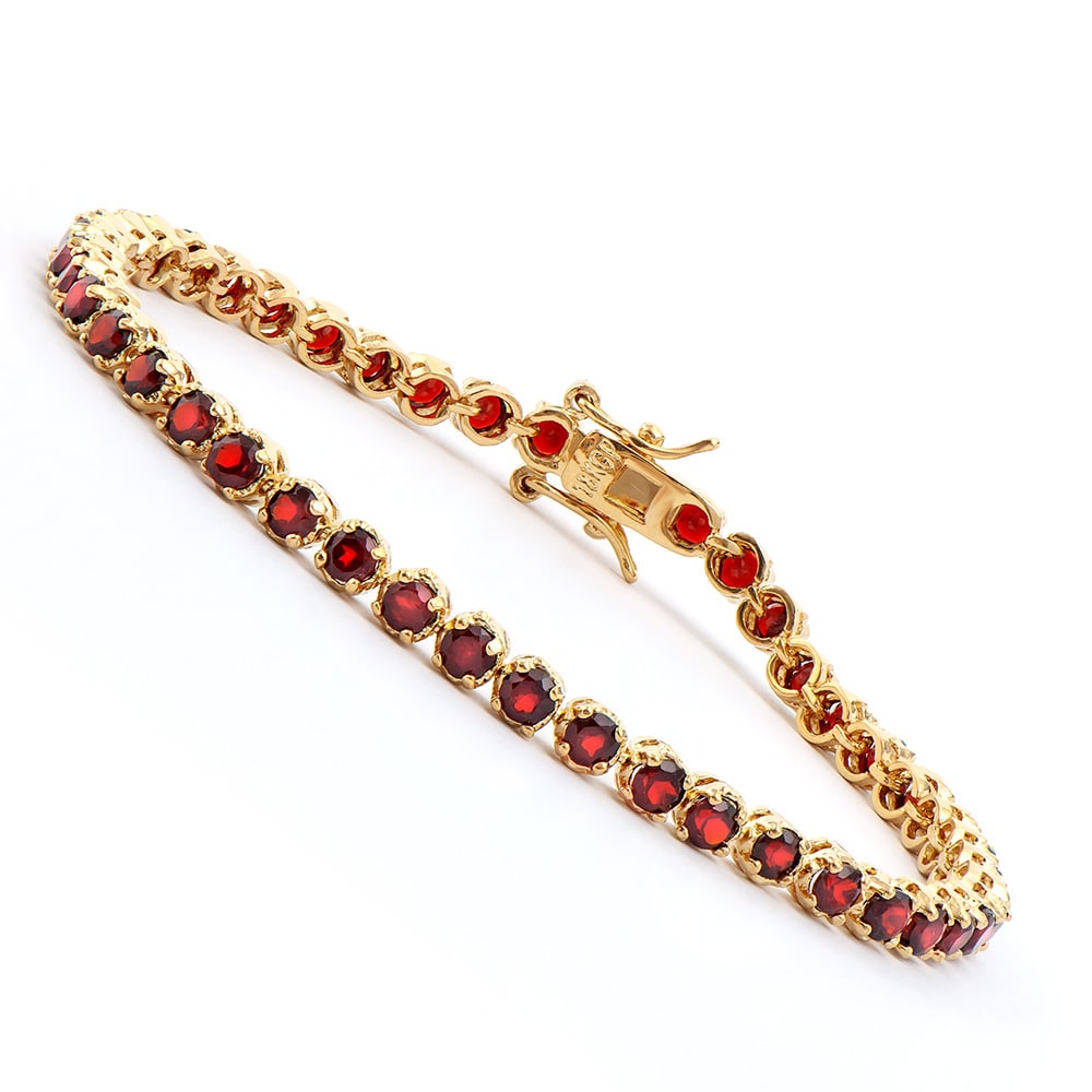 Plated 18KT Yellow Gold 3.60ctw Garnet Bracelet: One Plated 18KT Yellow Gold 3.60ctw Garnet Bracelet. (46) Garnet stones with a total weight of 3.60cts. Total weight of 6.85 grams of brass layered with 18K yellow gold. The length of this bracelet is