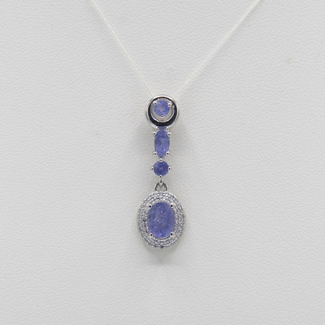 Certified Natural Tanzanite Pendant: Beautiful Certified Natural Tanzanite Pendant. These 4 100 % natural tanzanite's are mounted in elaborately designed solid .925 sterling silver. The tanzanite center stone measures approx. 9 x 7 mm. P