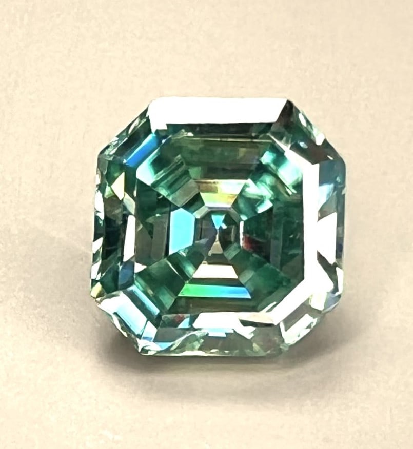 5.25 Ct Paraiba Green Rare Cushion Cut Fire Moissanite: Amazing VVs1 5.25 Ct Paraiba Green Cushion Cut Fire Moissanite. This Investment Grade Moissanite measures 10.15 x 10.15 mm. It is near flawless and bursting out with a full spectrum of colors. It has 
