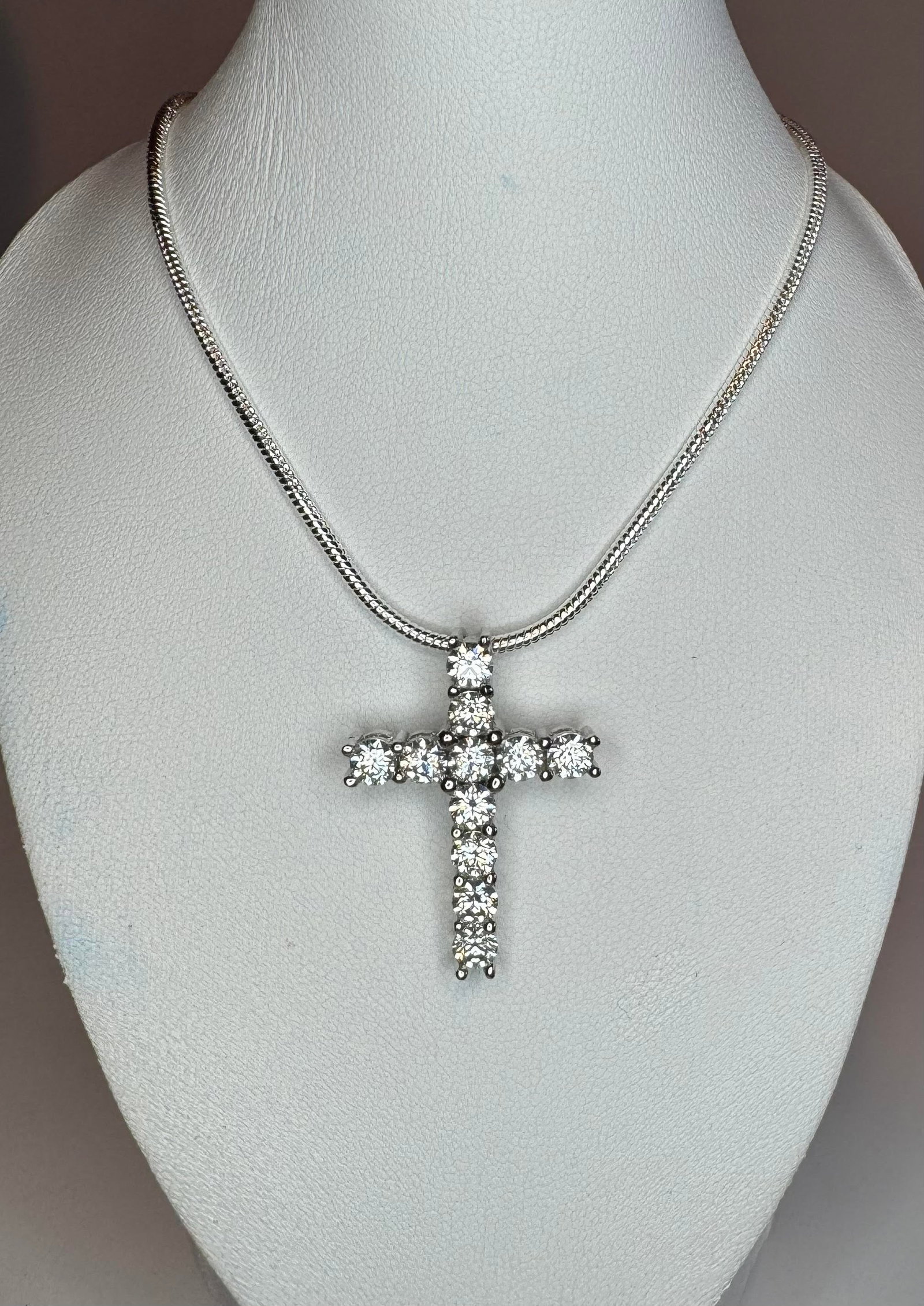 14 K White Gold Plate Fire Moissanite Cross Pendant: These 11 Fire Moissanites Are VVs1 eye clean brilliant round cuts measuring 3.8 mm. The color is F-G.With a refractive index of 2.65-2.69, These Fire Moissanites exhibits more brilliance and fire than