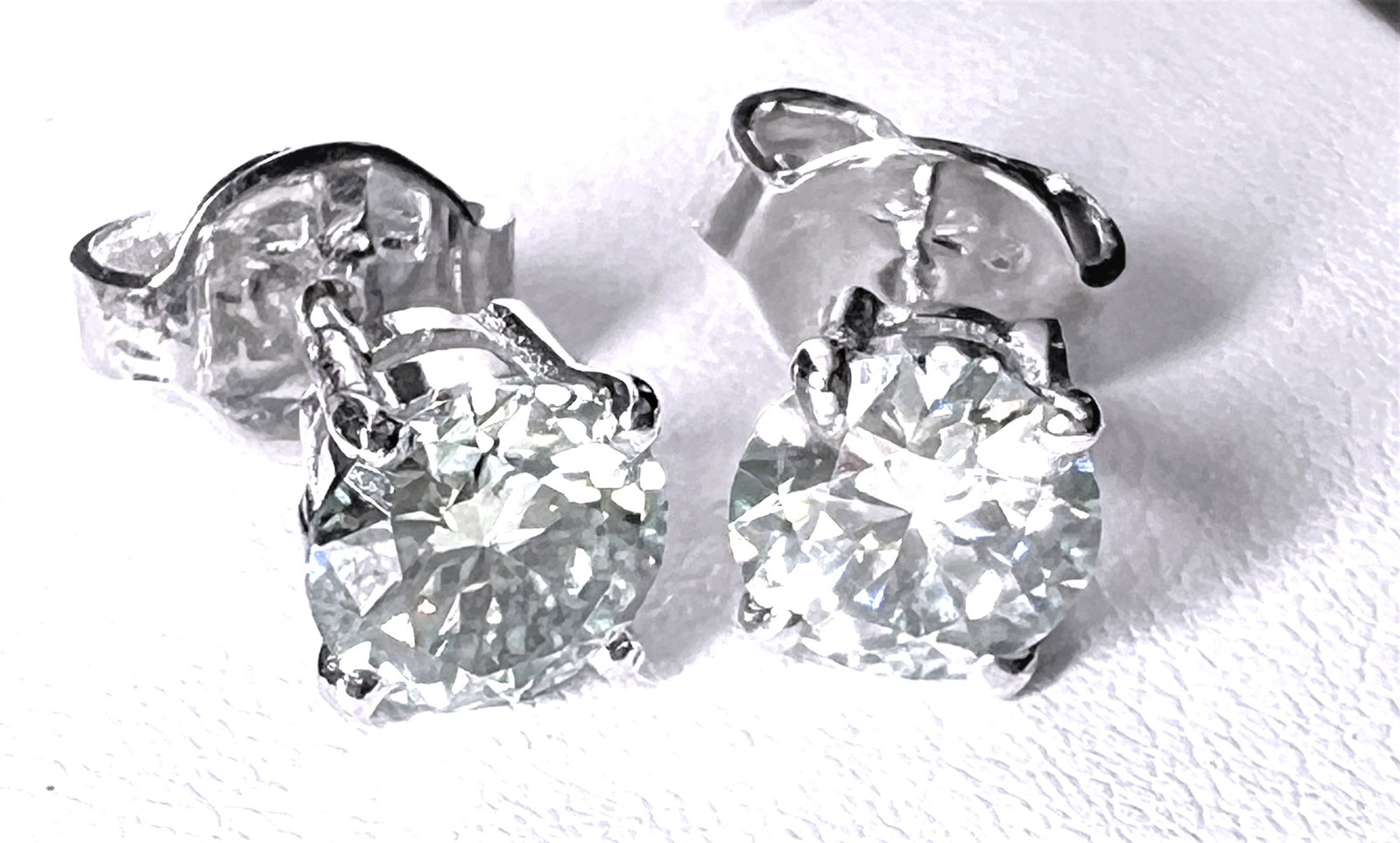 Sparkling 2.25 Ct VVs1 White Fire Moissanite Earrings: These Beautiful VVS1 Moissanite Earrings Are Near Flawless and bursting out with a full spectrum of colors. The Color is White H-I measuring . They are Brilliant Round Cuts Measuring Approx 6.2 mm eac