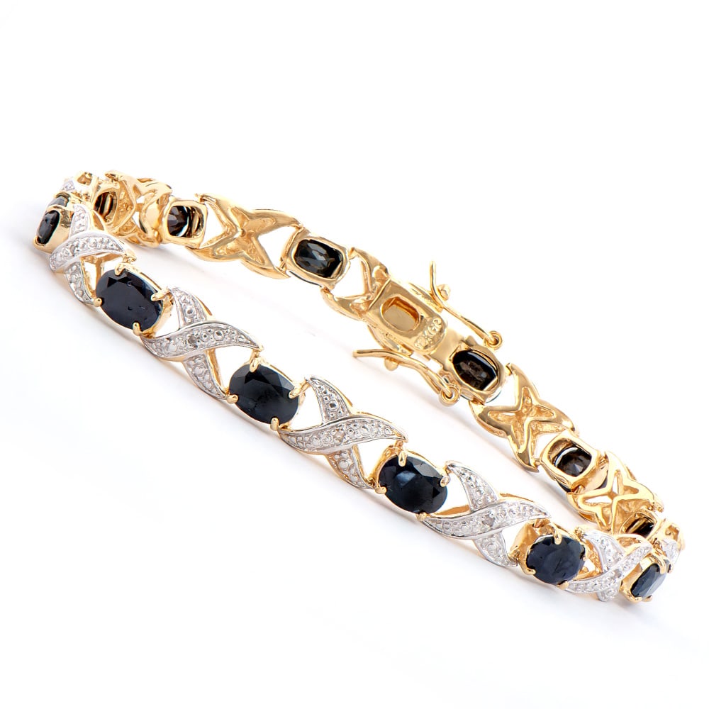 Plated 18KT Yellow Gold 12.00ctw Black Sapphire and Diamond Bracelet: One Plated 18KT Yellow Gold 12.00ctw Black Sapphire and Diamond Bracelet. (12) Black Sapphire stones measuring 7x5mm. (12) diamonds measuring 1.1mm with a total weight of 0.09cts. 12.25 grams of brass