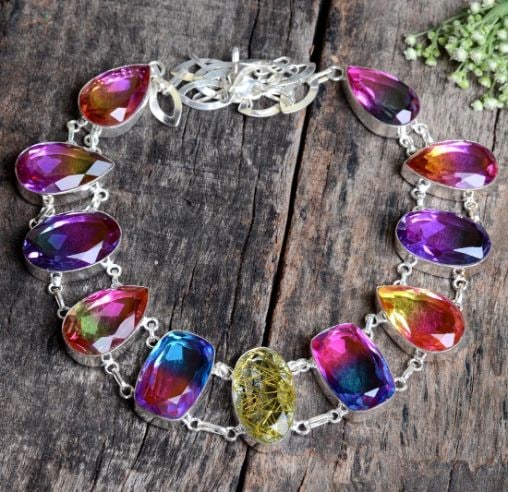 Beautiful Mixed Color Lab Created Quartz Necklace: These lab created gemstones are faceted mixed cuts. VVS1 eye clean. Mounted in .925 Sterling Silver Overlay.18" long.102.7 Total Grams or 513.5 Cttw. Get Ready For The Compliments On This One. Simply