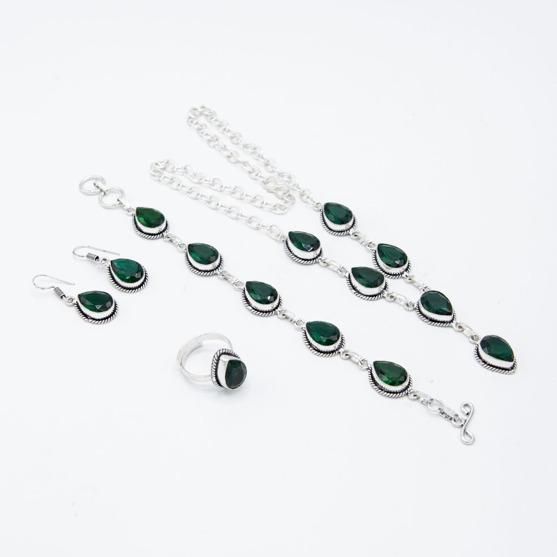 Stunning 4 Piece Complete Emerald Jewelry Set: These lab made emeralds are near flawless. They burst out with dazzling sparkle and a vivid even tone. The 4 piece set includes an 18 " necklace, 8" bracelet, earrings and a finger ring is adjustable 
