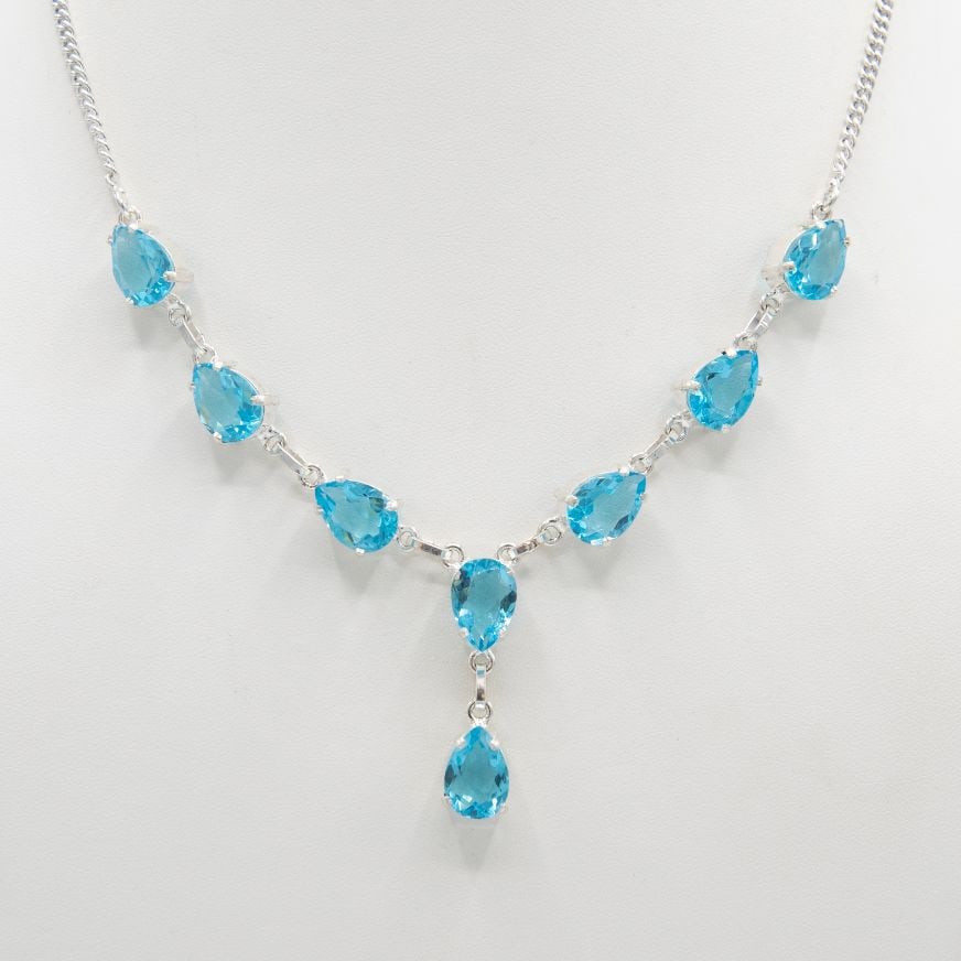 Breathtaking 54.5 Ct Swiss Blue Topaz Necklace: These 6 lab created topaz are VVS1 eye clean pear cuts mounted in .925 silver overlay.18 " gram wt is 25.5 total grams or 127.5 Cttw.