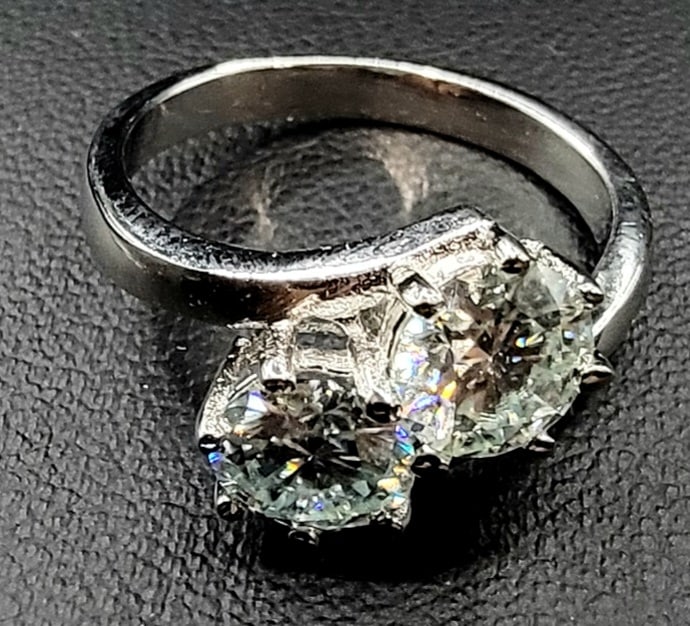 Twin Solitaire 3.15 Ct VVs1 Fire Moissanite Ring: These 2 Impressive Moissanites are both VVs1 eye clean G-H in color brilliant round cut measuring approx. 6.3 mm. They are both mounted in high polished Solid .925 Sterling Silver with 14 Kt White Gol