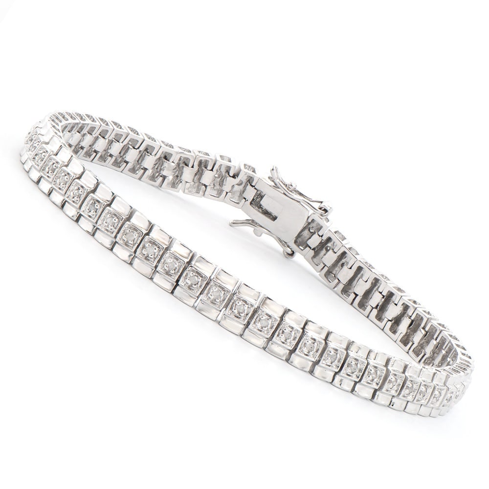Plated Rhodium 0.58ctw Diamond Bracelet: One Plated Rhodium 0.58ctw Diamond Bracelet. (58) round Diamonds with a color of I-J and clarity of I-3. Total weight of this bracelet is 14.75 grams. The length of this bracelet is 7 1/2 inches.