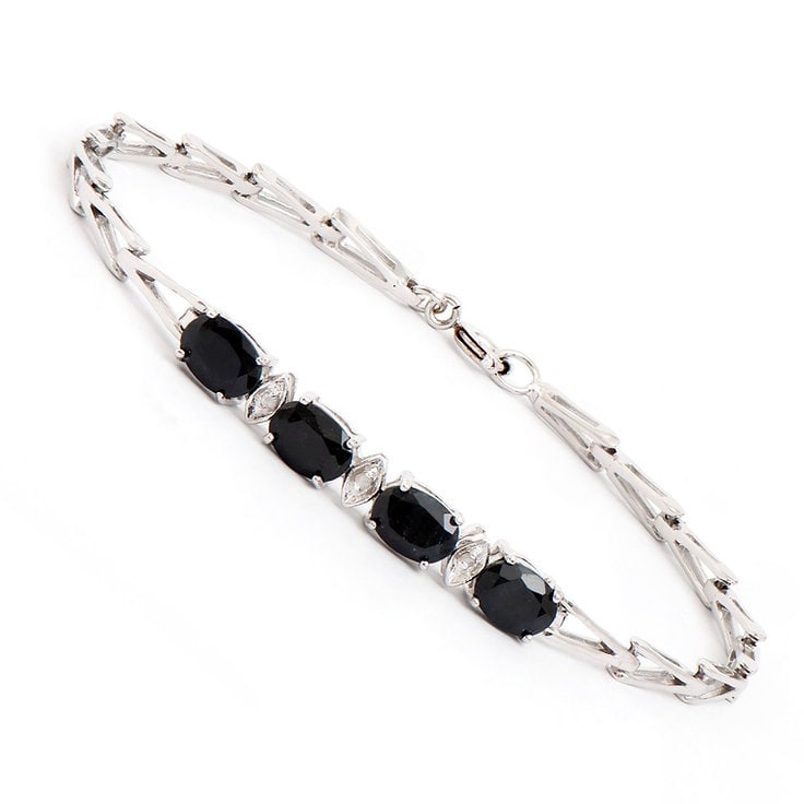 Plated Rhodium 4.05cts Black Sapphire and Diamond Bracelet: One Plated 4.05cts Black Sapphire and Diamond Rhodium Bracelet 7.5 in. (4) Black Sapphire stones with a total weight of 4.02cts. (3) diamonds with a total of 0.03cts with a color of H-I and clarity of