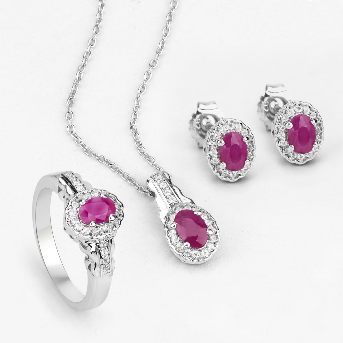 Plated Rhodium 2.08ctw Ruby and White Topaz Jewelry Set: 2.46 Carat Genuine Ruby and White Topaz.925 Sterling Silver 3 Piece Jewelry Set (Ring, Earrings, and Pendant w/ Chain).Ruby Oval/6x4mm - 4/2.08 ctw Prong Setting Natural Heat Treated F + White Topaz R